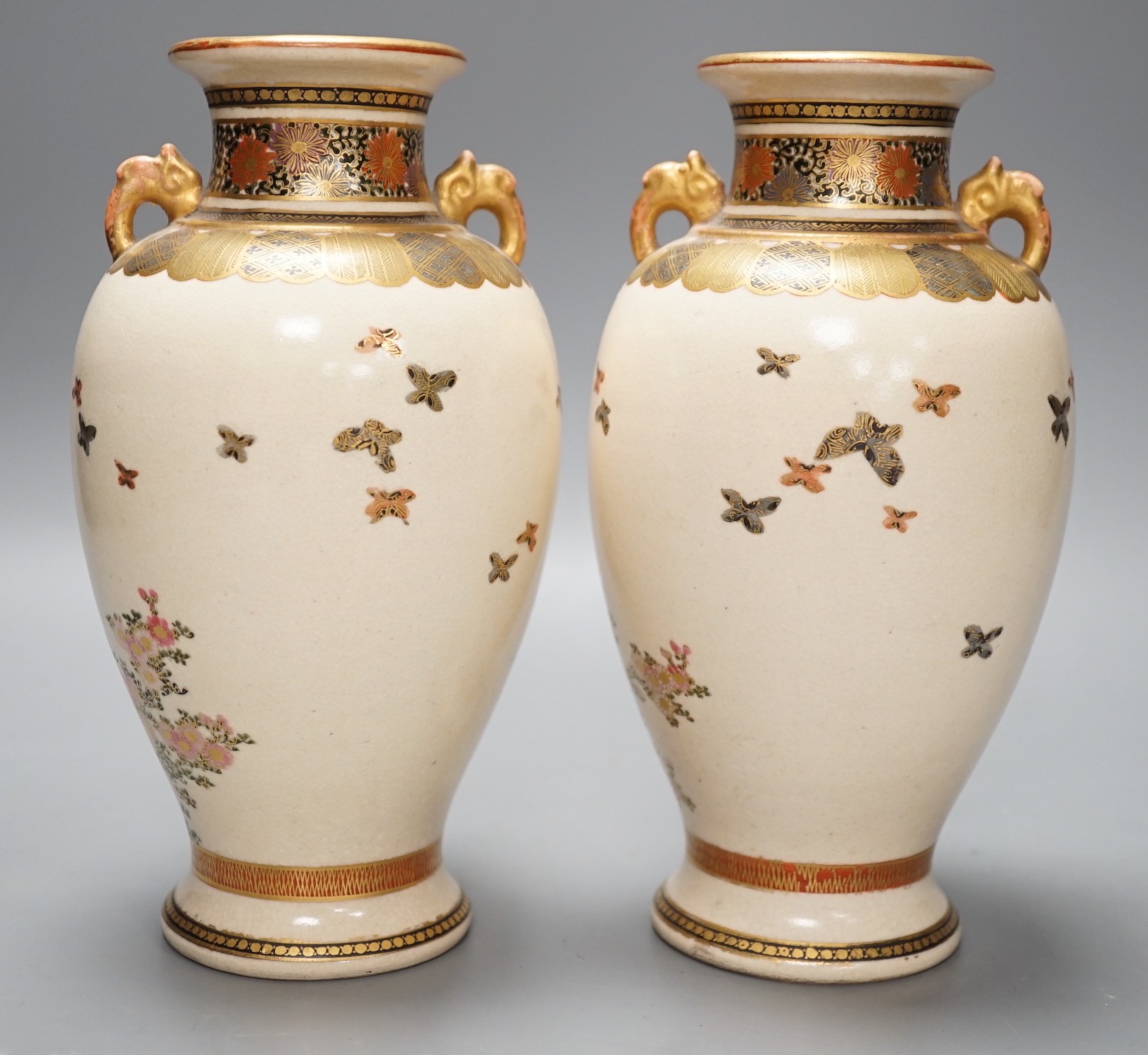 A pair of Japanese Satsuma pottery vases, 18.5cms high